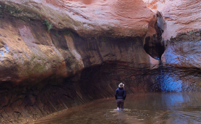  Kalen rolled up her pant legs and walked gingerly into the pool to pay homage to the spirit and life we had found in this hidden gorge. Running her hands through the trickling falls, taking a handful to drink and dotting her face with this water was like accepting a sacred gift. One that was alive and available to those open and accepting of her offering.